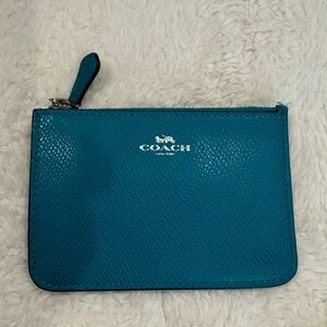 Turquoise Coach brand coin purse.